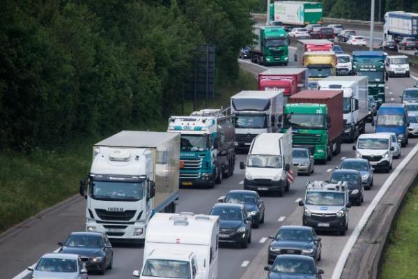   Lorries, commercial vehicles and cars driving on a motorway